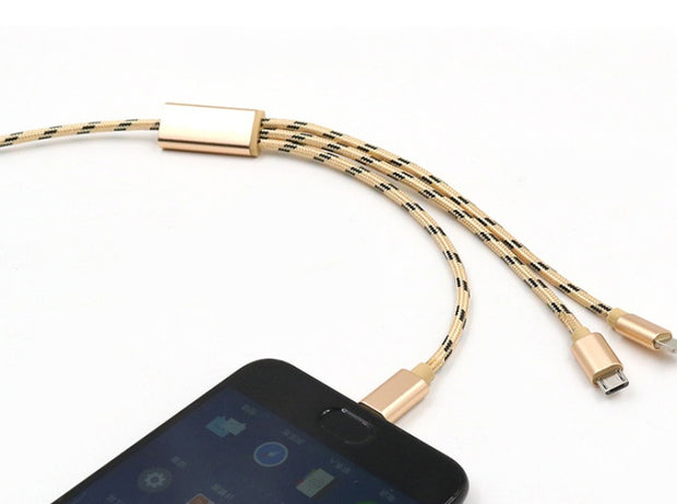 Three-in-one gold charging cable connected to a smartphone with Micro USB and TYPE-C connectors.