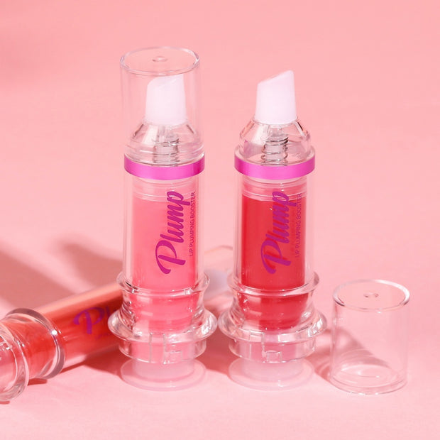 Two vibrant lip glosses in clear containers with pink accents on a pastel pink background.