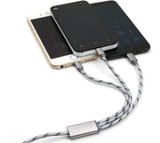 Three-in-one USB charging cable connected to three mobile phones in gold, black, and silver.