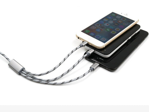 Three-in-one USB cable charging multiple mobile phones, showcasing Micro USB and TYPE-C connections.