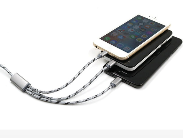 Three-in-one USB cable charging multiple mobile phones, showcasing Micro USB and TYPE-C connections.